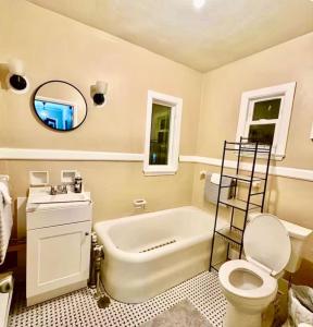 a bathroom with a tub and a toilet and a sink at Queen Bed Shared Common Space Carrier Dome SU Hospitals in Syracuse +10 photos