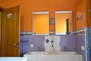 a bathroom with two sinks and two mirrors at Ciudad Rodrigo La Casa Azul in Ciudad-Rodrigo +34 photos