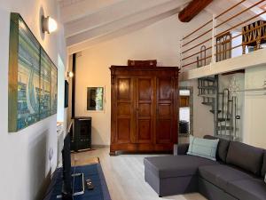 a living room with a couch and a wooden cabinet at Civico Cinque in Gravedona