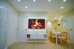 a living room with a tv on a wall at Silid Pahingahan at Forest Residences in Antipolo