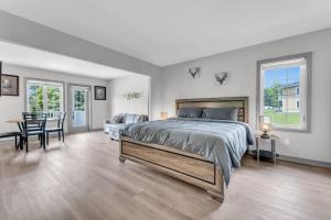 a bedroom with a large bed and a table and chairs at Lux Studio in Horseshoe Valley in Shanty Bay +27 photos