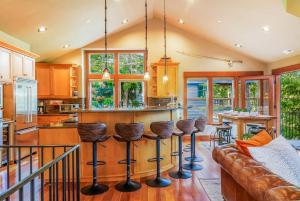 a kitchen with a couch and a bar with stools at 7th Heaven in Cle Elum