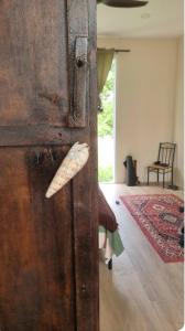 a wooden door with a door handle in a room at Baan kratay in Chaloklum
