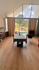 a living room with a table and a large window at Baan kratay in Chaloklum +5 photos