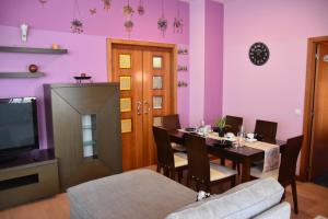 a dining room with a table and a tv at Ciudad Rodrigo La Casa Azul in Ciudad-Rodrigo