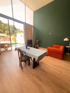 a living room with a table and a couch at Baan kratay in Chaloklum