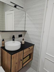 a bathroom with a sink and a mirror at Casa Gelín Azul in Santillana del Mar +6 photos