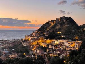a view of the city of positano at sunset at thalore room e apartments in Amantea +15 photos