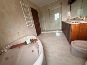 a bathroom with a tub and a toilet and a sink at thalore room e apartments in Amantea