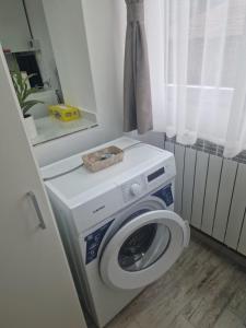 a washing machine in a room with a window at Central Studio in Târgu Secuiesc