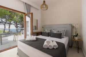 a bedroom with a bed with towels on it at Evripidis Hotel Afitos in Afitos +81 photos