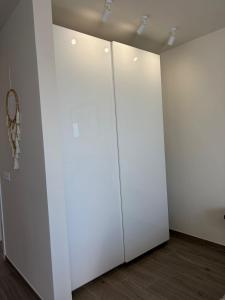 two white doors in a room with wood floors at Sanmarcos in Playa Paraiso +13 photos