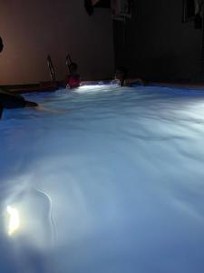 a group of people swimming in a swimming pool at Studio Apartment with Rooftop & Pool Access in Lagos +3 photos