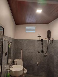 a bathroom with a sink and a toilet and a shower at Miu Villa in Ahangama +42 photos