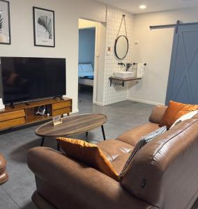 a living room with a couch and a flat screen tv at Mira Apartments 2BR Apartment in Nadi Free Parking & WiFi in Nadi