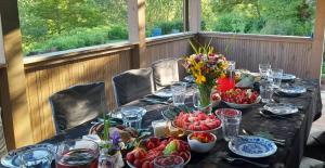 a long table with plates of food and flowers on it at Akacjowe Wzgórze in Wielęcin
