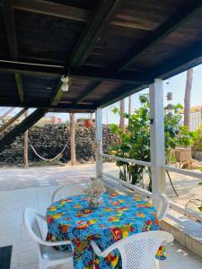 a table with a colorful table cloth on a patio at Mi bohío in Monteverde