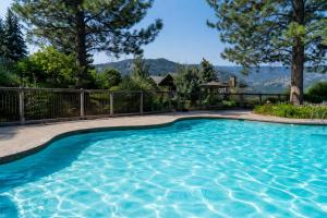 a swimming pool in a yard with a fence at Sun Mountain Lodge in Winthrop