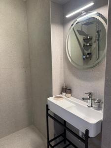a bathroom with a white sink and a mirror at Ntina Apartment - Loggos, Paxos in Longós +9 photos