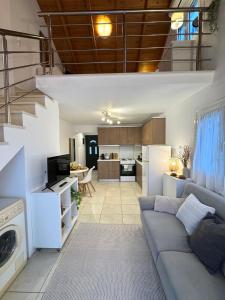 a living room with a couch and a kitchen at Ntina Apartment - Loggos, Paxos in Longós