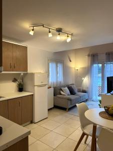 a kitchen and living room with a refrigerator and a couch at Ntina Apartment - Loggos, Paxos in Longós