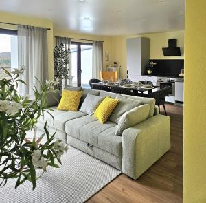 a living room with a couch and a kitchen at Luxus-Penthouse mit Panorama-View in Netphen