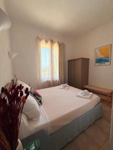 a bedroom with a bed with two towels on it at La Châtaigneraie in Evisa +10 photos