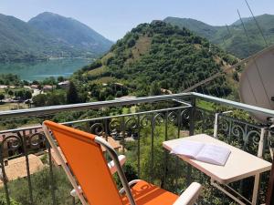 a table and chairs on a balcony with a view of a lake at Stanza con terrazzo vista lago LAKEHOLIDAY IT in Castel di Tora
