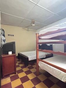 a room with two bunk beds and a tv at Hospedaje Chavela in Barrancabermeja
