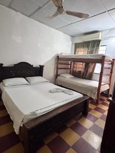 a bedroom with two bunk beds and a ceiling fan at Hospedaje Chavela in Barrancabermeja +29 photos