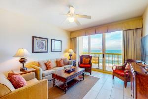 a living room with a couch and a table at Calypso 906W in Panama City Beach