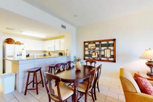 a kitchen and dining room with a table and chairs at Calypso 906W in Panama City Beach +31 photos