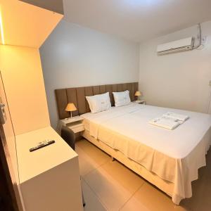 a bedroom with a large bed in a room at Rio Hotel in Petrolândia