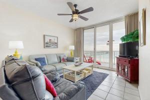 a living room with a couch and a ceiling fan at Summerwind 0402 in Navarre