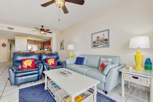 a living room with a couch and a table at Summerwind 0402 in Navarre