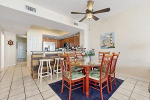 a dining room and kitchen with a table and chairs at Summerwind 0402 in Navarre