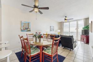 a dining room and living room with a table and chairs at Summerwind 0402 in Navarre +18 photos