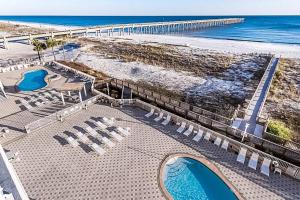 an aerial view of a beach with chairs and a pier at Summerwind 0402 in Navarre