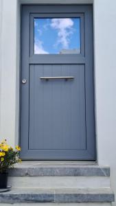 a blue door with a window on a building at Akro Astypalea in Astypalaia