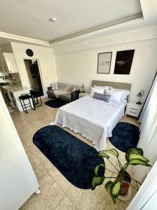 a bedroom with a bed and two blue rugs at Eda Sultan Guesthouse - 5 Min Walk to Göynük Beach in Kemer