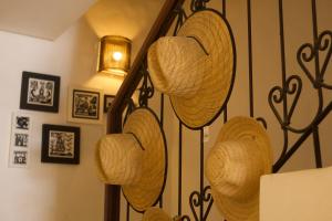 a bunch of baskets hanging on a wall at Maruê Guesthouse Porto de Pedras in Pôrto de Pedras