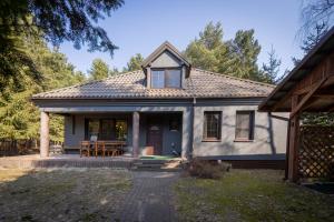a house with a porch and a patio at Domek nad rzeką in Joniec