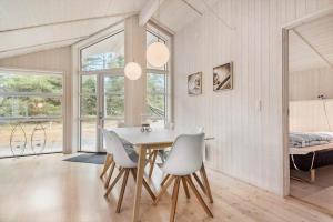 a dining room with a white table and chairs at VE303-Oksbol-Kaervej-2 in Oksbøl
