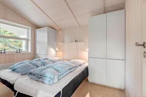 a large bed in a room with a window at VE303-Oksbol-Kaervej-2 in Oksbøl