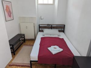 a bedroom with a bed with a red blanket at ANKU's in Krems an der Donau