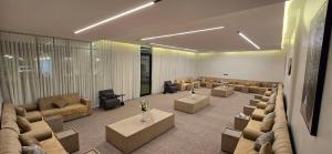a large room with couches and tables and chairs at قو اب إليت in Abā al Kibāsh