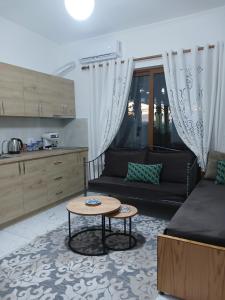 a living room with a couch and a table at Guest House Nino's in Çorovodë