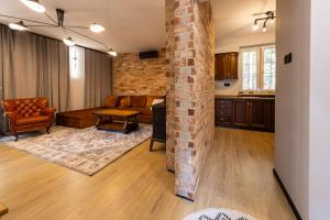 a living room with a brick wall at Domek nad rzeką in Joniec