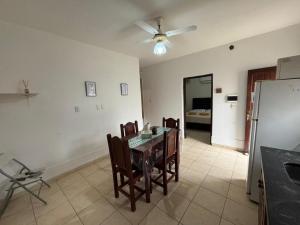 a dining room with a table with chairs and a ceiling fan at Tu casa en Ruta 34 - Wifi - Cochera -5 personas in Fernández