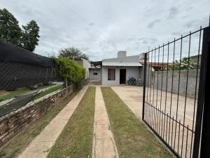 a fence in front of a house at Tu casa en Ruta 34 - Wifi - Cochera -5 personas in Fernández